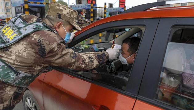 A militia member uses a digital thermometer to take a driver's temperature at a checkpoint at a highway toll gate in Wuhan in central China's Hubei Province, Thursday, Jan. 23, 2020. (AP file photo) A militia member uses a digital thermometer to take a driver's temperature at a checkpoint at a highway toll gate in Wuhan in central China's Hubei Province, Thursday, Jan. 23, 2020. (AP file photo)