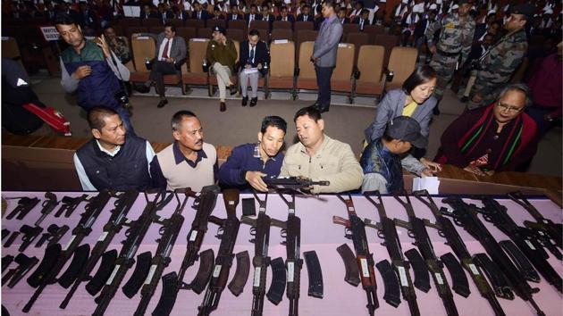Security personnel arrange arms and ammunitions to be put on display during the arms laying down ceremony at GMCH auditorium, in Guwahati, Assam. A total of 644 militants of eight banned insurgent outfits surrendered in Assam along with 177 arms. (PTI) 