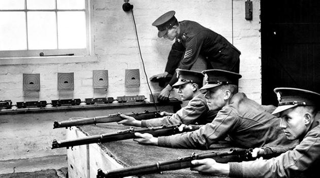With cardboard shooting targets fixed onto the carriages of an electric model train, a sergeant of the Royal Fusilier Regiment prepares to instruct new recruits on how to use the Short Magazine Lee–Enfield Mk III .303 bolt action rifle at their depot on 15 December 1938 in Hounslow, London.(Getty Images/photo for representational purpose)