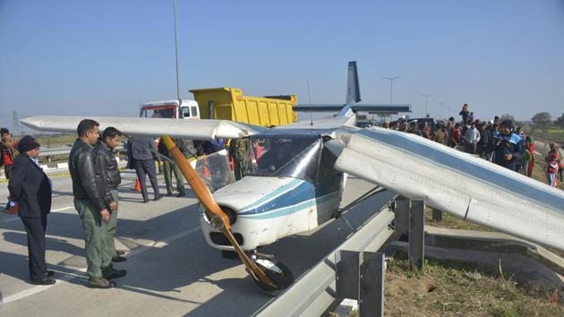 An NCC aircraft made an emergency landing after it developed snag, on the Eastern Peripheral Expressway, at Sadarpur, in Ghaziabad. Both pilots were safe and there was minor damage to aircraft. (Sakib Ali / HT Photo) 