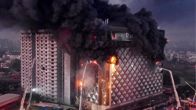 Fire fighters try to douse a blaze which broke out in a 10-storey building at Raghuvir Textiles Market in Surat, Gujarat. At least 50 fire tenders fought the billowing flames. (PTI) 
