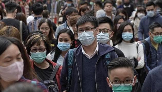 People wear masks on a street in Hong Kong.(AP) People wear masks on a street in Hong Kong.(AP)