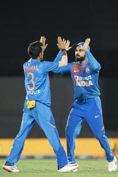 Indian captain Virat Kohli high fives Yuzvendra Chahal after he caught New Zealand's Kane Williamson. (AP) Indian captain Virat Kohli high fives Yuzvendra Chahal after he caught New Zealand's Kane Williamson. (AP)