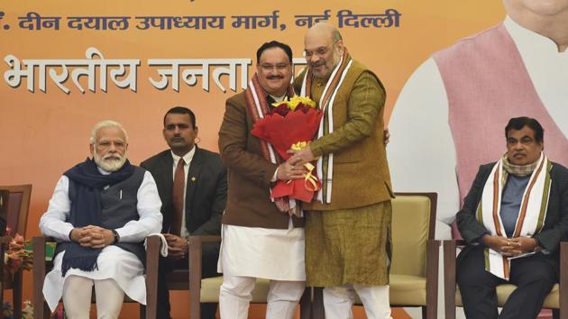 BJP leader JP Nadda is congratulated after been elected as the BJP National President by outgoing president and current Union Home Minister Amit Shah, in the presence of Prime Minister Narendra Modi and Minister for Road Transport & Highways Nitin Gadkari, at BJP headquarters, in New Delhi. (Sanjeev Verma / HT Photo) 