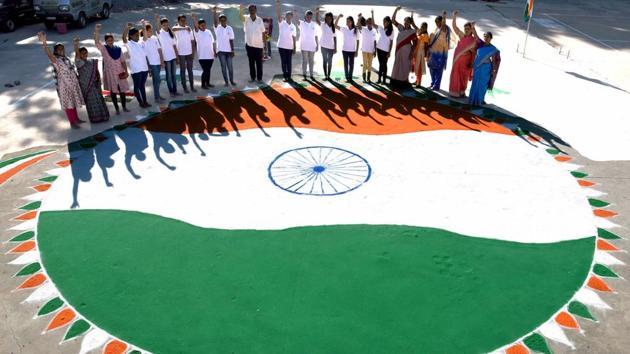 Karnataka, Jan 25 (ANI): People raise their hands as they make a rangoli of National flag flying on the eve of Republic Day, in Bengaluru on Saturday. (ANI Photo) 