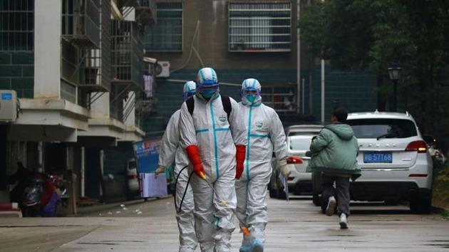 Workers from local disease control and prevention department in protective suits disinfect a residential area following the outbreak of a new coronavirus, in Ruichang, Jiangxi province, China.(REUTERS) Workers from local disease control and prevention department in protective suits disinfect a residential area following the outbreak of a new coronavirus, in Ruichang, Jiangxi province, China.(REUTERS)