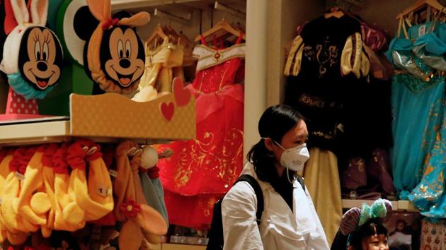 A child wears mask as she tries a themed ears at a souvenir shop in Disneyland hotel after Hong Kong Disneyland that has been closed, following the coronavirus outbreak in Hong Kong, China January 26, 2020.(REUTERS) A child wears mask as she tries a themed ears at a souvenir shop in Disneyland hotel after Hong Kong Disneyland that has been closed, following the coronavirus outbreak in Hong Kong, China January 26, 2020.(REUTERS)
