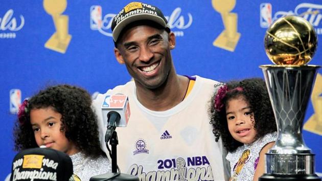 Los Angeles Lakers' Kobe Bryant, left, holding the Championship
