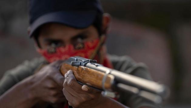 A boy aims a rifle as the Regional Coordinator of Community Authorities (CRAC-PF) community police force teaches a group of children how to use weapons, at a basketball court in the village of Ayahualtempan, Guerrero State, Mexico. The CRAC-PF vigilante group trains children as young as five so they can protect themselves from drug-related criminals groups operating in the area. (Pedro PARDO / AFP) A boy aims a rifle as the Regional Coordinator of Community Authorities (CRAC-PF) community police force teaches a group of children how to use weapons, at a basketball court in the village of Ayahualtempan, Guerrero State, Mexico. The CRAC-PF vigilante group trains children as young as five so they can protect themselves from drug-related criminals groups operating in the area. (Pedro PARDO / AFP)