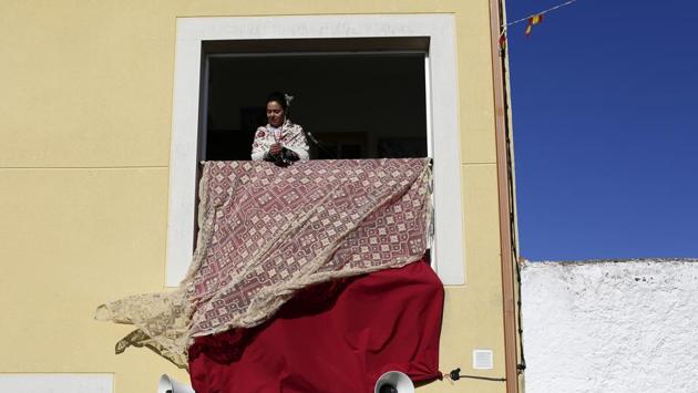 A woman dressed in traditional costume watches from a balcony the traditional "Carantonas" festival. Like many fiestas, the origin of this one is unclear. Some say it’s a representation of the legend of wild animals receiving Saint Sebastian following his martyrdom. (Manu Fernandez / AP)