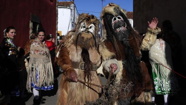 People in traditional costumes take part in the traditional "Las Carantonas" festival. (Manu Fernandez / AP)