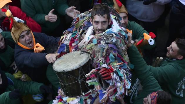 A man is lifted by people after playing the Jarramplas. These days, the “jarramplas” are cushioned by gloves and chest shields. Again, the festival’s origins are uncertain but there’s general belief that a thief was once hounded out of the village under a hail of raw vegetables. (Manu Fernandez / AP)