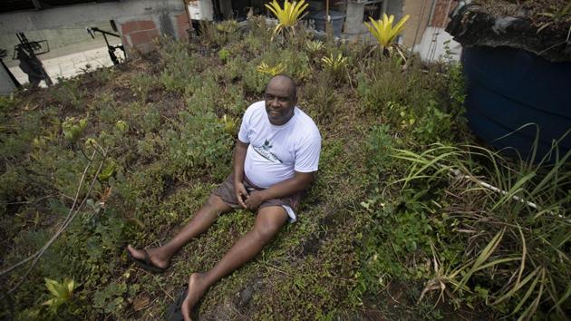 Deeper inside the favela, Luis Cassiano has set up a garden atop his home. As more and more houses cropped up over the last three decades, he felt the temperature rise to a point that became unbearable. The sun would set behind the far-off rainforest, but his home’s interior wouldn’t cool until after midnight. (Silvia Izquierdo / AP) Deeper inside the favela, Luis Cassiano has set up a garden atop his home. As more and more houses cropped up over the last three decades, he felt the temperature rise to a point that became unbearable. The sun would set behind the far-off rainforest, but his home’s interior wouldn’t cool until after midnight. (Silvia Izquierdo / AP)