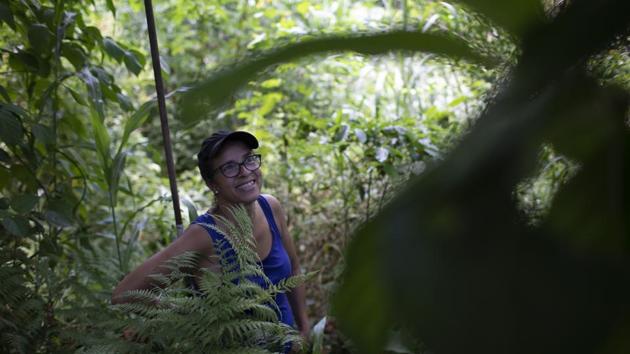 Ale Roque wandered an untamed orchard in Rio de Janeiro, pushing aside leaves to point out what she helped plant last year. “This is cacao, developing well ... look at this lime tree, it’s full ... lots and lots of tomato ... that one’s acai ...,” she told AP. It seems there’s always more. “Ginger... Avocado... Pineapple... Sweet potato.” (Silvia Izquierdo / AP) Ale Roque wandered an untamed orchard in Rio de Janeiro, pushing aside leaves to point out what she helped plant last year. “This is cacao, developing well ... look at this lime tree, it’s full ... lots and lots of tomato ... that one’s acai ...,” she told AP. It seems there’s always more. “Ginger... Avocado... Pineapple... Sweet potato.” (Silvia Izquierdo / AP)