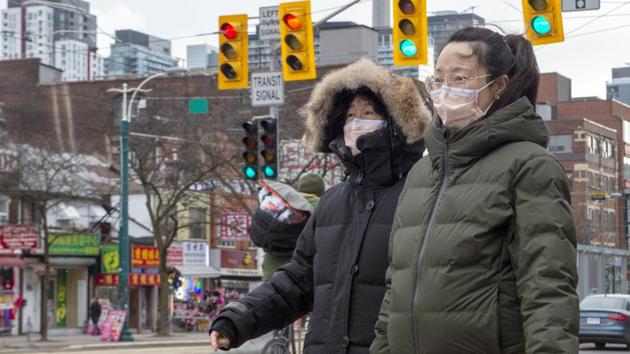 Pedestrians in China wear protective masks as Coronavirus spreads across the country and world.(AP Photo) Pedestrians in China wear protective masks as Coronavirus spreads across the country and world.(AP Photo)