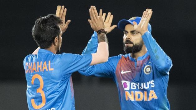 Indian cricket team captain Virat Kohli high fives Yuzvendra Chahal.(AP)