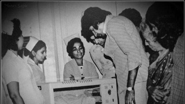 Amitabh Bachchan gazes at newborn Abhishek Bachchan.