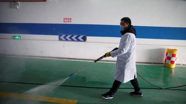 A worker sprays the underground parking of an office building with disinfectant in Changsha, in China’s Hunan province on January 29.(Reuters Photo) A worker sprays the underground parking of an office building with disinfectant in Changsha, in China’s Hunan province on January 29.(Reuters Photo)