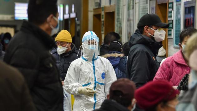 A medical staff member (C) wearing protective clothing seen at the Wuhan Red Cross Hospital in Wuhan. Overwhelmed staff, patients waiting for hours to see a doctor, people fending for themselves: Wuhan residents describe scenes of chaos from one swamped hospital struggling to cope with crowds who may be infected by the new coronavirus. (Hector RETAMAL / AFP) A medical staff member (C) wearing protective clothing seen at the Wuhan Red Cross Hospital in Wuhan. Overwhelmed staff, patients waiting for hours to see a doctor, people fending for themselves: Wuhan residents describe scenes of chaos from one swamped hospital struggling to cope with crowds who may be infected by the new coronavirus. (Hector RETAMAL / AFP)