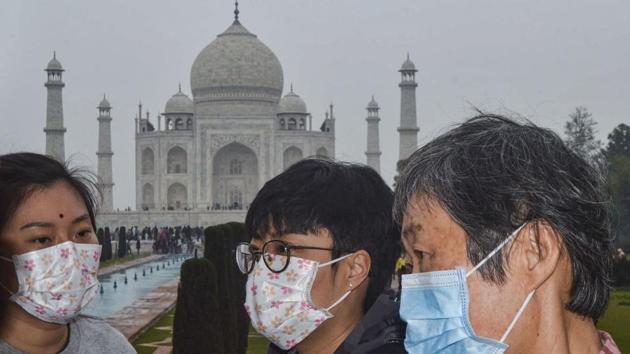 Agra: Tourists, wearing protective face masks, visit Taj Mahal, in Agra, Tuesday, Jan. 28, 2020. The Centre on Monday decided to take steps for possible evacuation of over 250 Indians from the Chinese city of Wuhan, the epicentre of the coronavirus outbreak, and announced a raft of precautionary measures to deal with suspected cases.(PTI)