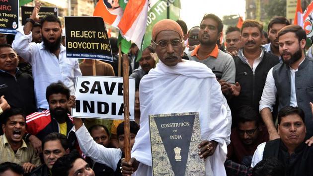 A West Bengal Pradesh Congress Committee member dressed as Gandhi holds the India Constitution during a protest march against the CAA, NRC and NPR in Kolkata, West Bengal.(Photo: Samir Jana/ Hindustan Times) A West Bengal Pradesh Congress Committee member dressed as Gandhi holds the India Constitution during a protest march against the CAA, NRC and NPR in Kolkata, West Bengal.(Photo: Samir Jana/ Hindustan Times)