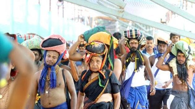 A woman is seen among the crowd of devotees at the Pamba base camp of Sabarimala Temple.(Photo: Vivek R Nair/ Hindustan Times)