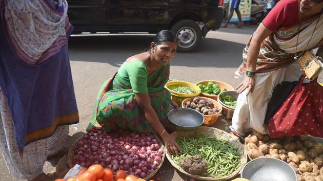 Saroj Ahire buys vegetables at a local market in Mumbai. With rising prices prompting her to think twice about what she eats—onions are now a luxury rather than a staple—planning for the future is impossible. Working for wealthy households only makes her feel worse, said Ahire, who shares a cramped one-room shanty with four family members. (Punit Paranjpe / AFP) Saroj Ahire buys vegetables at a local market in Mumbai. With rising prices prompting her to think twice about what she eats—onions are now a luxury rather than a staple—planning for the future is impossible. Working for wealthy households only makes her feel worse, said Ahire, who shares a cramped one-room shanty with four family members. (Punit Paranjpe / AFP)