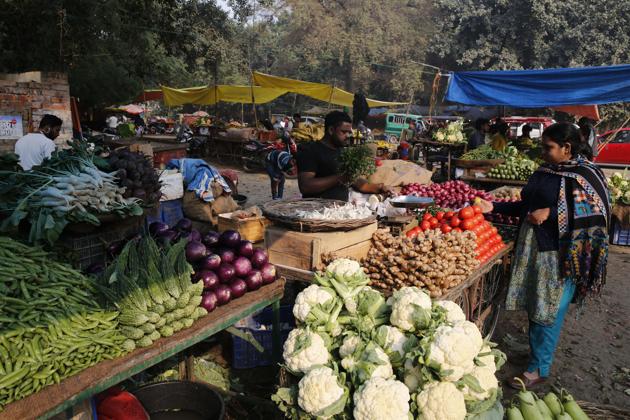 A women shops for vegetables at a market in Prayagraj, India.(AP)