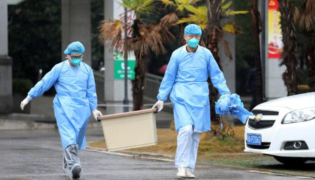 Medical staff carry a box as they walk at the Jinyintan hospital, where the patients with pneumonia caused by the new strain of coronavirus are being treated, in Wuhan, Hubei province, China.(Reuters File Photo)