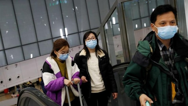 Passengers wear masks at Hong Kong West Kowloon High Speed Train Station Terminus.(Reuters)