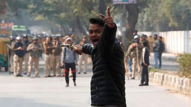 An unidentified man reacts as he brandishes a gun during a protest against amended citizenship law outside the Jamia Millia Islamia university in New Delhi on January 30, 2020.(REUTERS)