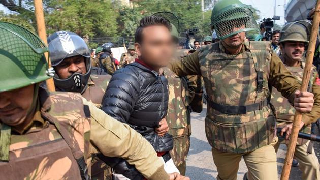 Police detain an unidentified person (face blurred as his being an adult could not be ascertained), after he allegedly brandished a gun and opened fire towards students protesting against the Citizenship Amendment Act, near Jamia Millia Islamia University, in New Delhi. (PTI) Police detain an unidentified person (face blurred as his being an adult could not be ascertained), after he allegedly brandished a gun and opened fire towards students protesting against the Citizenship Amendment Act, near Jamia Millia Islamia University, in New Delhi. (PTI)