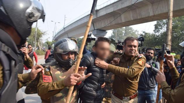 Police detain an unidentified person after he opened fire towards students protesting against the Citizenship Amendment Act, near Jamia Millia Islamia University, in New Delhi, on Jan. 30, 2020.(PTI) Police detain an unidentified person after he opened fire towards students protesting against the Citizenship Amendment Act, near Jamia Millia Islamia University, in New Delhi, on Jan. 30, 2020.(PTI)