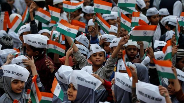 School children wearing caps attend Republic Day celebrations in Ahmedabad.(REUTERS)