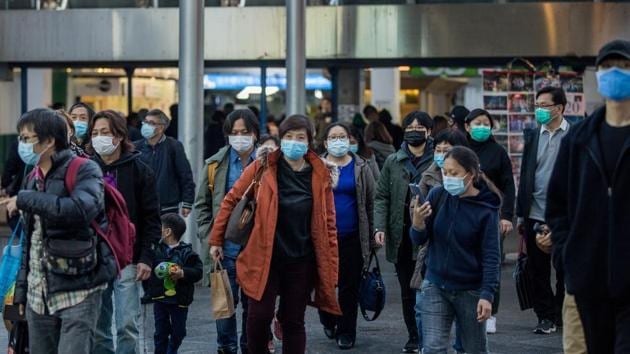 Pedestrians wearing masks walk out of a ferry pier terminal in the Tsim She Tsui district in Hong Kong, China.(Bloomberg) Pedestrians wearing masks walk out of a ferry pier terminal in the Tsim She Tsui district in Hong Kong, China.(Bloomberg)