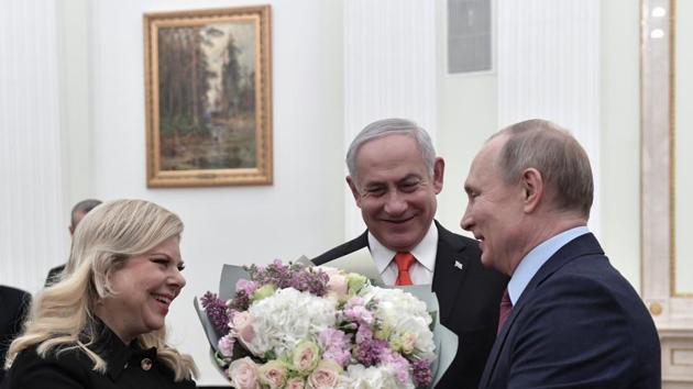 Russian President Vladimir Putin, right, greets Israeli Prime Minister Benjamin Netanyahu's wife Sara, left, as Israeli Prime Minister Benjamin Netanyahu stands in the center prior to their talks in the Kremlin in Moscow, Russia, Thursday, Jan. 30, 2020. Netanyahu visited Moscow to discuss the U.S. Mideast peace plan with Putin and take an Israeli woman who had been jailed in Russia back home.(AP) Russian President Vladimir Putin, right, greets Israeli Prime Minister Benjamin Netanyahu's wife Sara, left, as Israeli Prime Minister Benjamin Netanyahu stands in the center prior to their talks in the Kremlin in Moscow, Russia, Thursday, Jan. 30, 2020. Netanyahu visited Moscow to discuss the U.S. Mideast peace plan with Putin and take an Israeli woman who had been jailed in Russia back home.(AP)