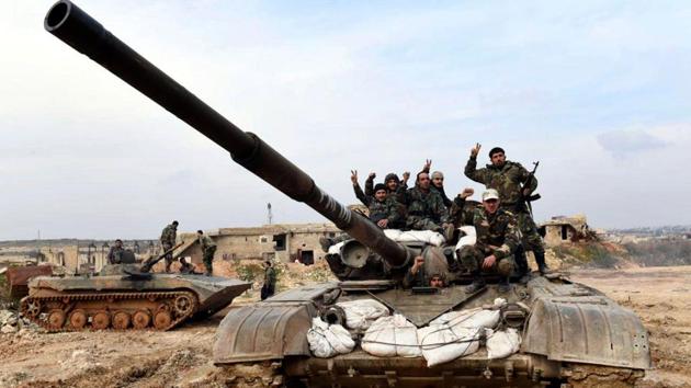 Syrian army soldiers flash the victory sign as they stand on their tank in western rural Aleppo. Syria’s nearly nine-year conflict has left more than 400,000 people dead and displaced half of Syria’s population, including more than 5 million who are refugees, mostly in neighbouring countries. (Ghaith Alsayed / AP) Syrian army soldiers flash the victory sign as they stand on their tank in western rural Aleppo. Syria’s nearly nine-year conflict has left more than 400,000 people dead and displaced half of Syria’s population, including more than 5 million who are refugees, mostly in neighbouring countries. (Ghaith Alsayed / AP)