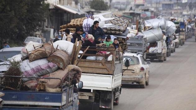 Syrian refugees head northwest through the town of Hazano in Idlib province. The Britain-based Syrian Observatory for Human Rights, an opposition war monitor, said insurgents withdrew from the town late Tuesday. Syrian troops had left a road west of the town opened apparently to give a chance for insurgents to pull out and to avoid street battles inside the town. (Ghaith Alsayed / AP) Syrian refugees head northwest through the town of Hazano in Idlib province. The Britain-based Syrian Observatory for Human Rights, an opposition war monitor, said insurgents withdrew from the town late Tuesday. Syrian troops had left a road west of the town opened apparently to give a chance for insurgents to pull out and to avoid street battles inside the town. (Ghaith Alsayed / AP)