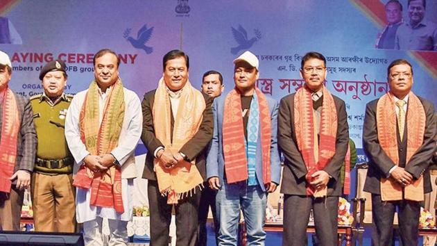 Assam chief minister Sarbananda Sonowal (fourth right) with NDFB chief Ranjan Daimary (second right) and others during an arms laying down ceremony in Guwahati on Thursday(PTI)