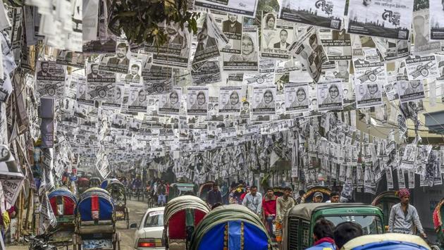 Commuters make their way on a street adorned with election posters laminated with plastic in Dhaka. The Bangladeshi capital is awash with millions of plastic-laminated campaign posters ahead of elections in the capital, and environmentalists are up in arms. (Munir uz Zaman / AFP) Commuters make their way on a street adorned with election posters laminated with plastic in Dhaka. The Bangladeshi capital is awash with millions of plastic-laminated campaign posters ahead of elections in the capital, and environmentalists are up in arms. (Munir uz Zaman / AFP)