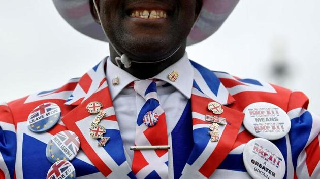 A pro-Brexit supporter smiles as he poses at Parliament Square on Brexit day, in London, England. The United Kingdom officially left the European Union on January 31. (Toby Melville / REUTERS) A pro-Brexit supporter smiles as he poses at Parliament Square on Brexit day, in London, England. The United Kingdom officially left the European Union on January 31. (Toby Melville / REUTERS)