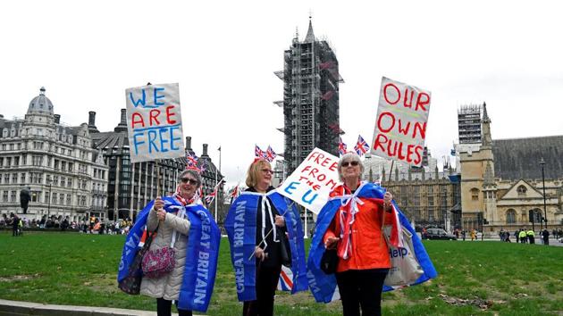 Pro-Brexit supporters pose at Parliament Square on Brexit day, in London.(REUTERS) Pro-Brexit supporters pose at Parliament Square on Brexit day, in London.(REUTERS)
