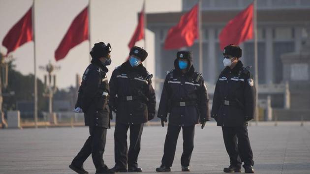 Police officers wearing masks are seen at at the Tiananmen Square, as the country is hit by an epidemic of the new coronavirus, in Beijing, China.(REUTERS)