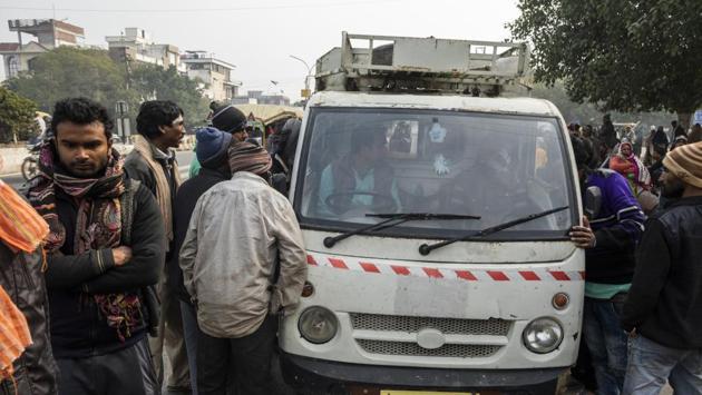 Day labourers seeking work speak to the driver of a truck.Suraj Kumar, 25, a construction worker, who migrated to Delhi from Bihar, and among those waiting said, “Earlier, everyone would get work for about 25 days in a month, but now even five to 10 days is a lot.” (Prashanth Vishwanathan / Bloomberg) Day labourers seeking work speak to the driver of a truck.Suraj Kumar, 25, a construction worker, who migrated to Delhi from Bihar, and among those waiting said, “Earlier, everyone would get work for about 25 days in a month, but now even five to 10 days is a lot.” (Prashanth Vishwanathan / Bloomberg)
