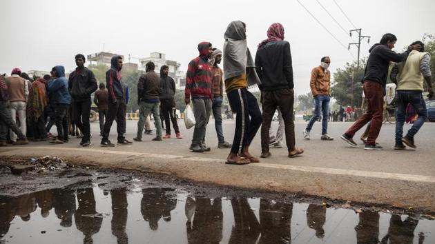 Day labourers reflected in a puddle. The International Monetary Fund last week slashed India’s growth forecast for this year by 1.2 percentage points to 5.8%, citing the nation as a reason for cutting its global outlook. Despite tentative signs that the worst may be over, growth isn’t set to reach the 9%-10% pace needed to combat extreme poverty. The goal of a $5 trillion economy is becoming more distant. (Prashanth Vishwanathan / Bloomberg) Day labourers reflected in a puddle. The International Monetary Fund last week slashed India’s growth forecast for this year by 1.2 percentage points to 5.8%, citing the nation as a reason for cutting its global outlook. Despite tentative signs that the worst may be over, growth isn’t set to reach the 9%-10% pace needed to combat extreme poverty. The goal of a $5 trillion economy is becoming more distant. (Prashanth Vishwanathan / Bloomberg)