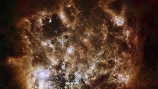 Large Magellanic Cloud galaxy in infrared light as seen by the Herschel Space Observatory, a European Space Agency-led mission, and NASA's Spitzer Space Telescope. Spitzer, the NASA astronomers said, also found a previously undetected ring around Saturn, composed of sparse dust particles that visible-light observatories cannot see. (PTI / AP) Large Magellanic Cloud galaxy in infrared light as seen by the Herschel Space Observatory, a European Space Agency-led mission, and NASA's Spitzer Space Telescope. Spitzer, the NASA astronomers said, also found a previously undetected ring around Saturn, composed of sparse dust particles that visible-light observatories cannot see. (PTI / AP)