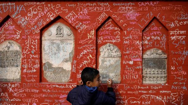 A boy writes on the wall of a Saraswati temple during the Shreepanchami festival dedicated to the Hindu goddess of education Saraswati in belief that the goddess will help devotees excel in education, in Kathmandu, Nepal. (Navesh Chitrakar / REUTERS) A boy writes on the wall of a Saraswati temple during the Shreepanchami festival dedicated to the Hindu goddess of education Saraswati in belief that the goddess will help devotees excel in education, in Kathmandu, Nepal. (Navesh Chitrakar / REUTERS)