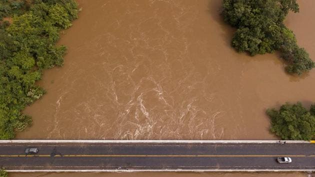 A bridge almost consumed by flood water on the border of the municipalities of Diamantina and Olhos D’Agua in Minas Gerais state, Brazil. The levels of the Jequitinhonha River have risen following severe flooding, which has already claimed close to 50 confirmed deaths and almost 19,000 people have been forced from their homes due to flood or landslide damage. (Nilmar Lage / AFP) A bridge almost consumed by flood water on the border of the municipalities of Diamantina and Olhos D’Agua in Minas Gerais state, Brazil. The levels of the Jequitinhonha River have risen following severe flooding, which has already claimed close to 50 confirmed deaths and almost 19,000 people have been forced from their homes due to flood or landslide damage. (Nilmar Lage / AFP)