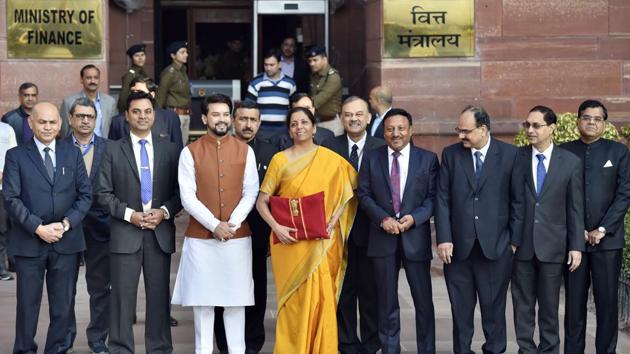 Finance Minister Nirmala Sitharaman with MoS Anurag Thakur as she heads to Parliament to present the budget. For a second time, Sitharaman again opted for a bahi khata, a traditional cloth wrapped ledger. The budget was expected to bring cuts in personal income tax and sops, especially for rural and agriculture sectors, in order to give a push to the economy. (Ajay Aggarwal / HT Photo) Finance Minister Nirmala Sitharaman with MoS Anurag Thakur as she heads to Parliament to present the budget. For a second time, Sitharaman again opted for a bahi khata, a traditional cloth wrapped ledger. The budget was expected to bring cuts in personal income tax and sops, especially for rural and agriculture sectors, in order to give a push to the economy. (Ajay Aggarwal / HT Photo)