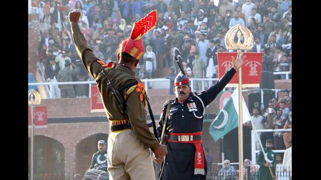 A Border Security Force (BSF) personnel and Pakistani Ranger take part in the Beating Retreat ceremony during the 71st Republic Day celebration at Wagah-Attari border post near Amritsar, Punjab. (Sameer Sehgal / HT Photo)